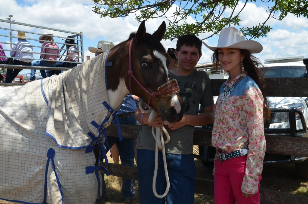 Liam Christina-Holland and Sophia Foster with Gizmo the horse at the Warwick saleyards for the horse sale. 